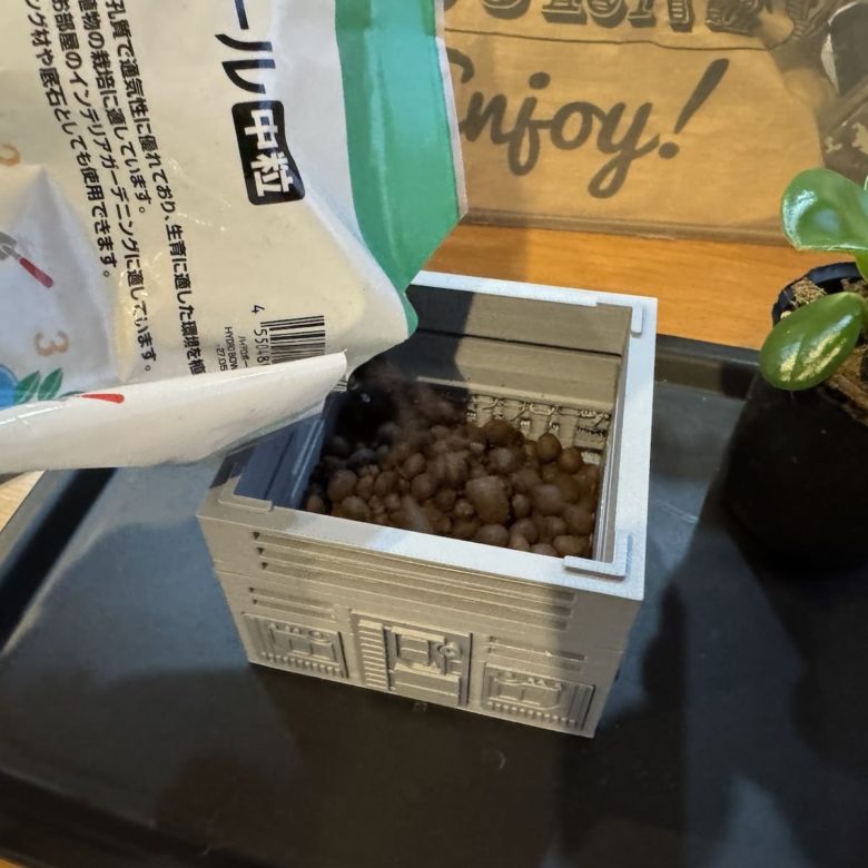 3Dプリンタで作った鉢植えに土を入れている様子
